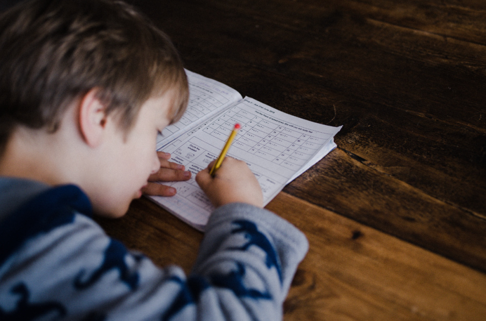 Kid doing schoolwork in what teachers and parents can do for anxiety at school