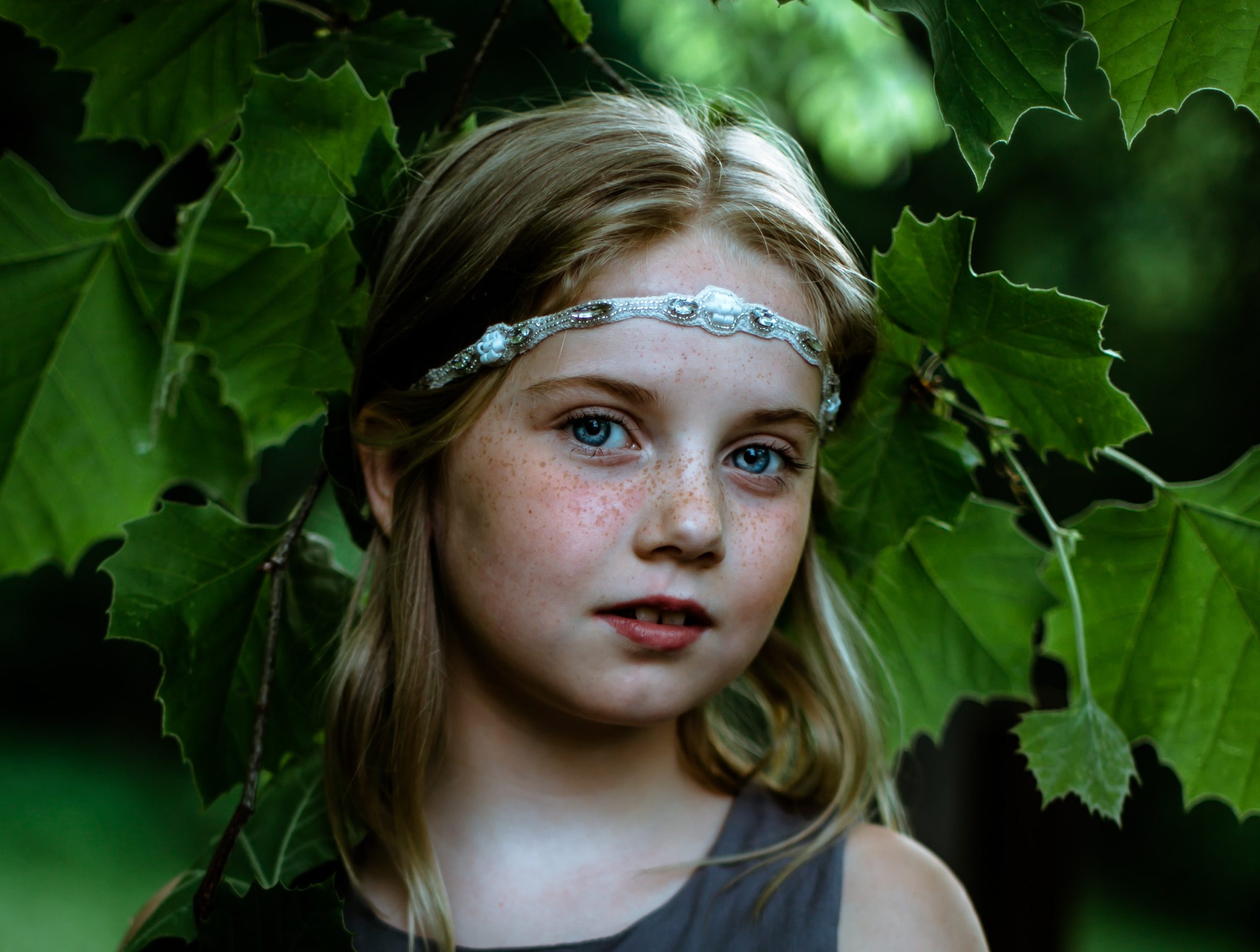 Girl with leaves looking at the camera